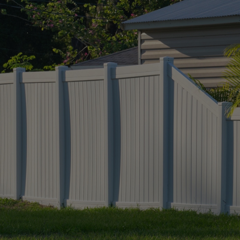 White fences outside home sunny day